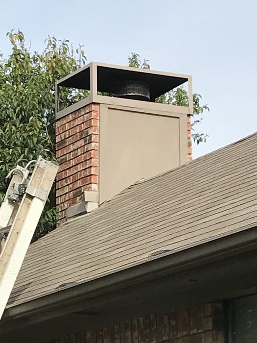 Rebuilt chimney chase with new siding and custom metal cap